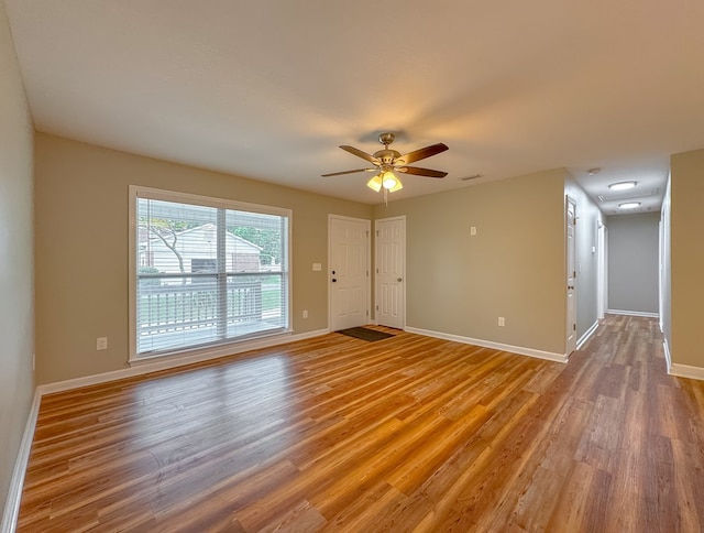 unfurnished room with hardwood / wood-style floors and ceiling fan