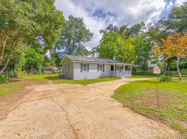 ranch-style house with a front yard and cooling unit