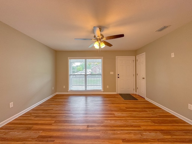 spare room featuring ceiling fan and light hardwood / wood-style floors