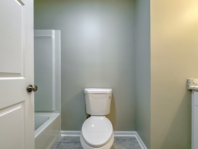 bathroom featuring vanity, toilet, and a tub