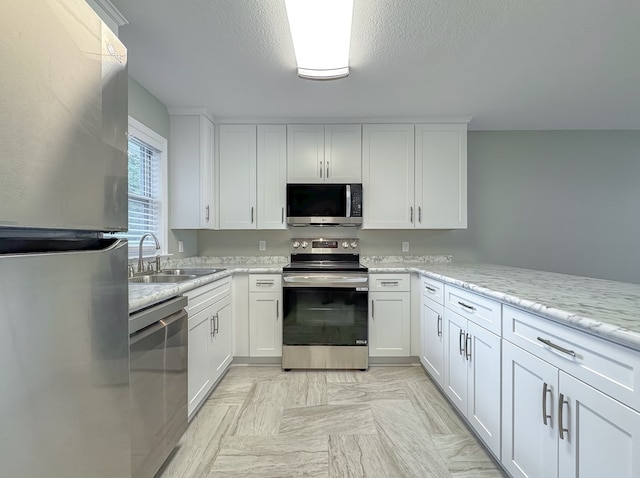 kitchen featuring sink, white cabinetry, and stainless steel appliances