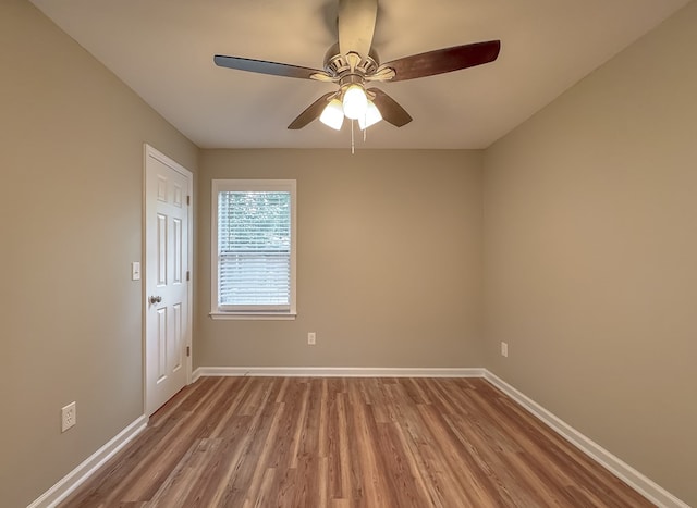 spare room featuring wood-type flooring and ceiling fan