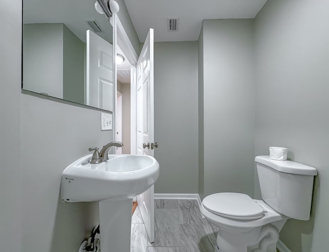 bathroom featuring toilet and sink