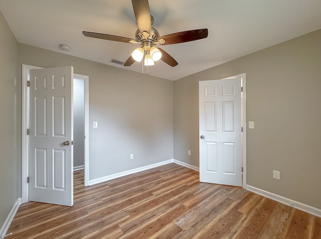 spare room with light hardwood / wood-style floors and ceiling fan