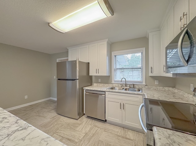 kitchen featuring light stone countertops, sink, white cabinetry, and stainless steel appliances