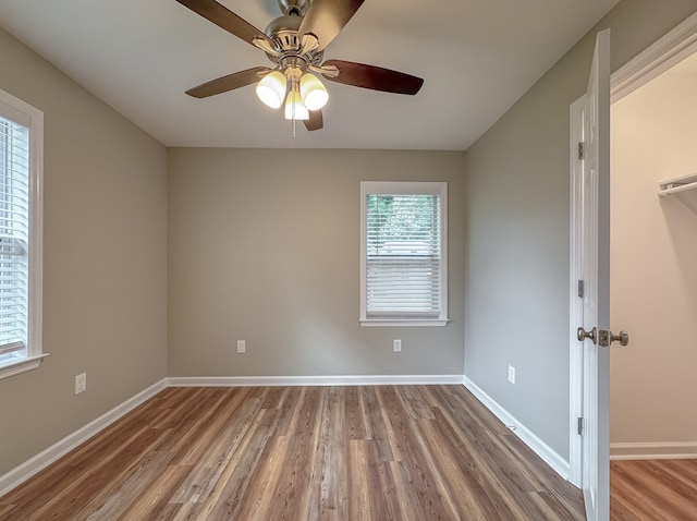 empty room featuring hardwood / wood-style floors and ceiling fan