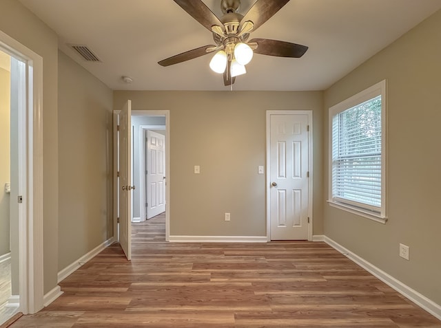 unfurnished bedroom with ceiling fan and light hardwood / wood-style floors