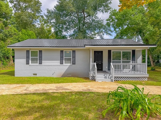 ranch-style home featuring a front yard and a porch