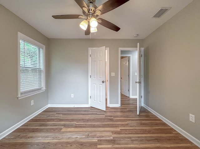 unfurnished bedroom featuring light hardwood / wood-style floors and ceiling fan