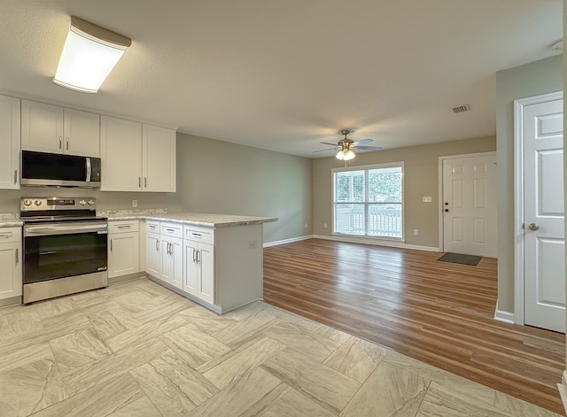 kitchen with white cabinetry, ceiling fan, stainless steel appliances, light hardwood / wood-style flooring, and kitchen peninsula