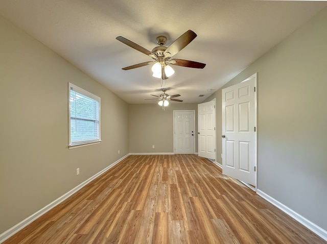 unfurnished room featuring ceiling fan, light hardwood / wood-style floors, and lofted ceiling