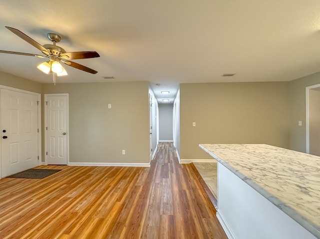 unfurnished living room featuring hardwood / wood-style flooring and ceiling fan