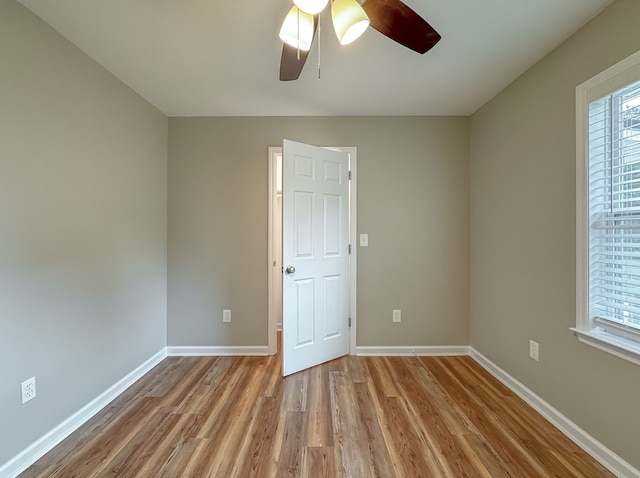 unfurnished room featuring light wood-type flooring and ceiling fan