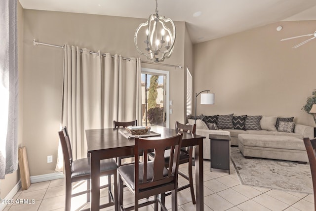 dining area with light tile patterned floors, baseboards, lofted ceiling, and ceiling fan with notable chandelier