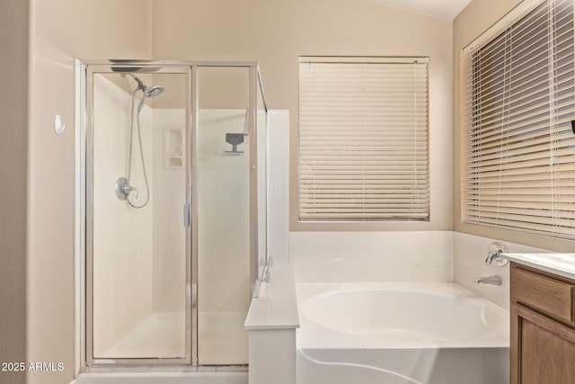 bathroom with vanity, a shower stall, and a bath