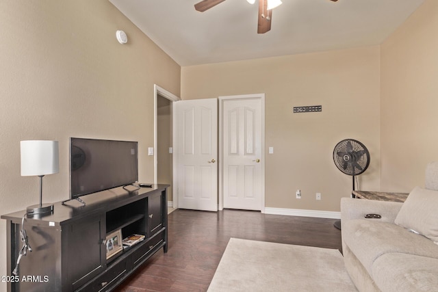 living room with a ceiling fan, dark wood-style floors, and baseboards