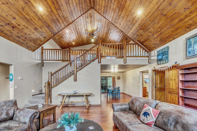 living area featuring baseboards, wood ceiling, stairway, hardwood / wood-style floors, and high vaulted ceiling