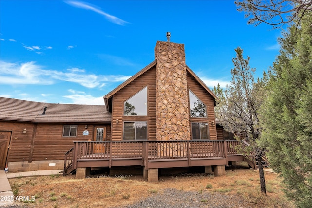 rear view of property featuring crawl space, a chimney, a deck, and log veneer siding