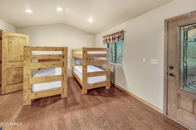 bedroom with lofted ceiling, baseboards, wood finished floors, and recessed lighting