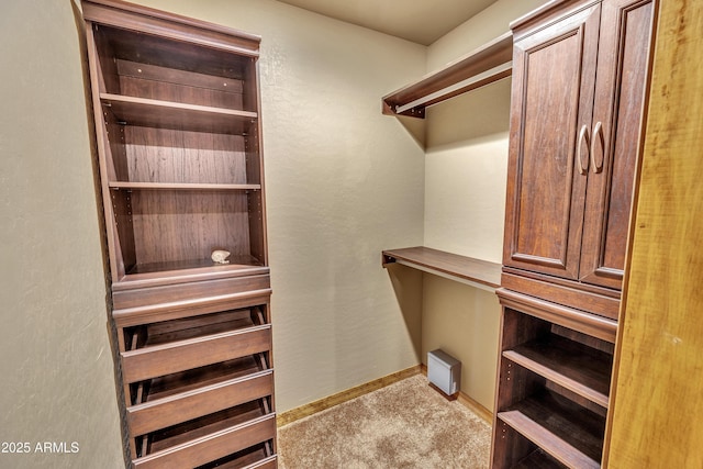 walk in closet featuring carpet