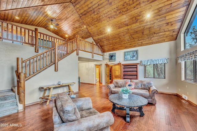 living area featuring stairs, high vaulted ceiling, wooden ceiling, and wood-type flooring