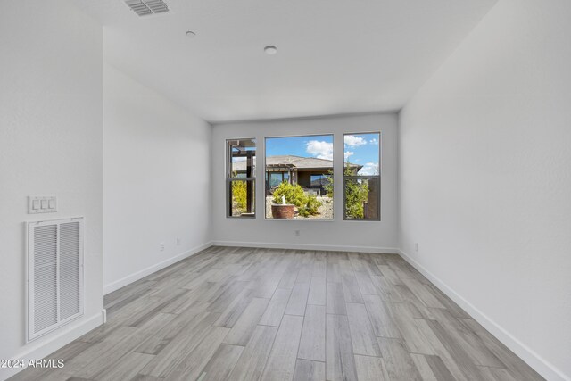 unfurnished room featuring light hardwood / wood-style floors