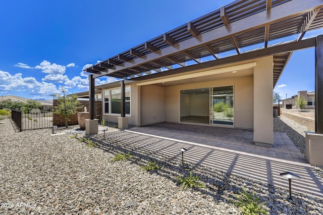 rear view of house featuring a patio and a pergola