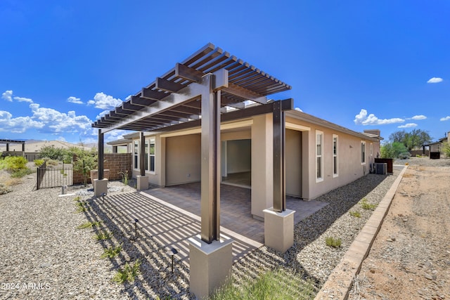 rear view of house featuring a pergola and a patio