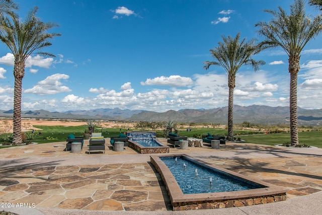 view of swimming pool featuring a mountain view and a patio area