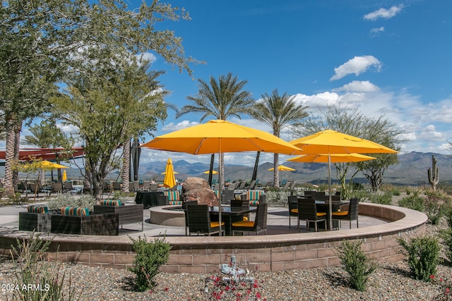 view of jungle gym featuring a mountain view and a patio area