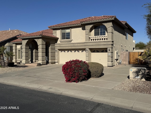 mediterranean / spanish-style home with a garage