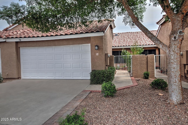 3510 E Hampton Ave Unit 74, Mesa, AZ 85204 - view of front facade with driveway, a tiled roof, stucco siding, a gate, and fence