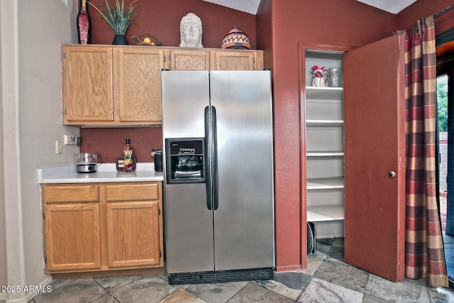 3510 E Hampton Ave Unit 74, Mesa, AZ 85204 - kitchen featuring stainless steel fridge with ice dispenser, light countertops, and light stone finish flooring
