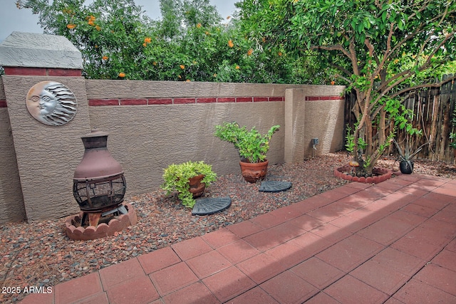 3510 E Hampton Ave Unit 74, Mesa, AZ 85204 - view of patio with an outdoor fire pit and a fenced backyard