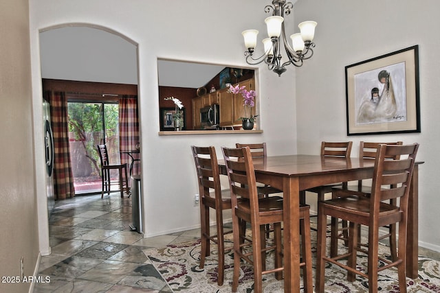 3510 E Hampton Ave Unit 74, Mesa, AZ 85204 - dining area featuring baseboards, stone tile flooring, and a chandelier