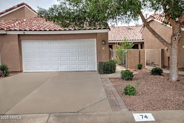 3510 E Hampton Ave Unit 74, Mesa, AZ 85204 - mediterranean / spanish-style house with driveway, a tiled roof, stucco siding, a gate, and a garage