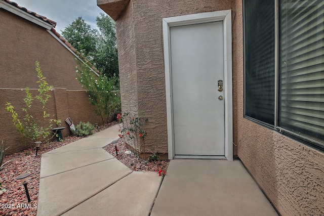 3510 E Hampton Ave Unit 74, Mesa, AZ 85204 - view of exterior entry featuring stucco siding and a patio