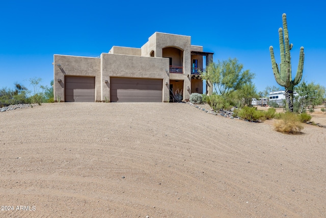 adobe home featuring a garage