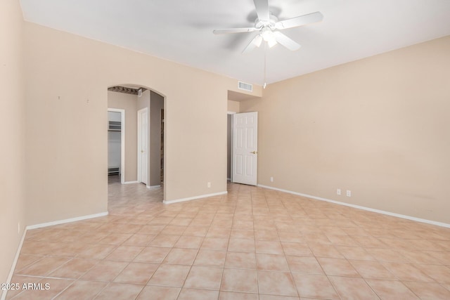 8874 W Piute Ave, Peoria, AZ 85382 - spare room with arched walkways, ceiling fan, baseboards, and light tile patterned floors