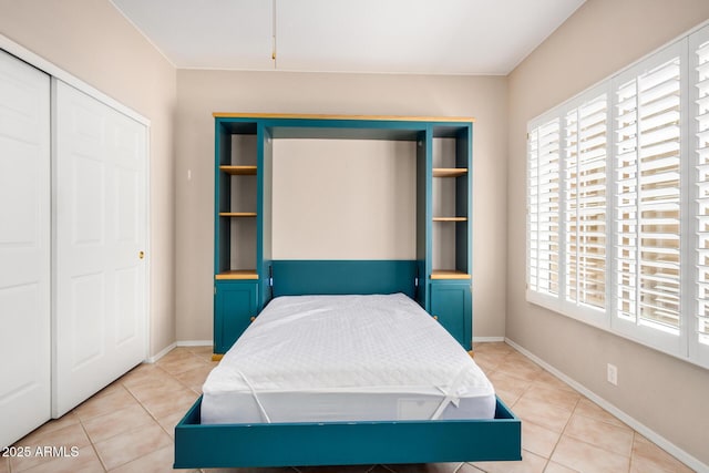8874 W Piute Ave, Peoria, AZ 85382 - bedroom with multiple windows, a closet, and light tile patterned floors