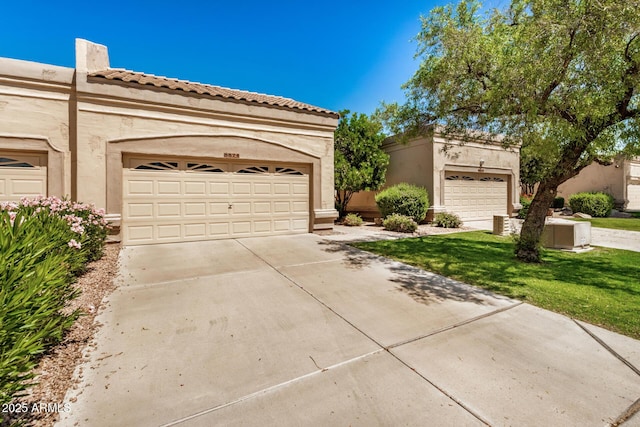 8874 W Piute Ave, Peoria, AZ 85382 - view of front of home with a garage, stucco siding, a tiled roof, and a front lawn