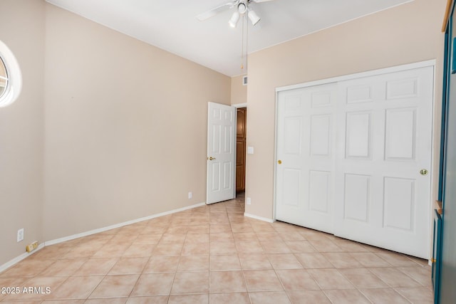8874 W Piute Ave, Peoria, AZ 85382 - unfurnished bedroom with light tile patterned flooring, a closet, ceiling fan, and baseboards