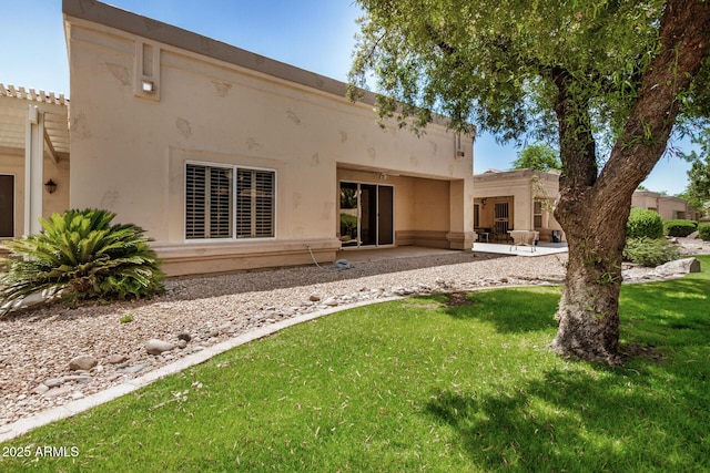 8874 W Piute Ave, Peoria, AZ 85382 - rear view of house with a lawn, stucco siding, and a patio area
