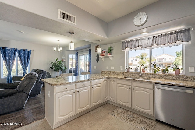 242 E Stonebridge Dr, Gilbert, AZ 85234 - kitchen with dishwasher, a sink, open floor plan, a peninsula, and light stone countertops