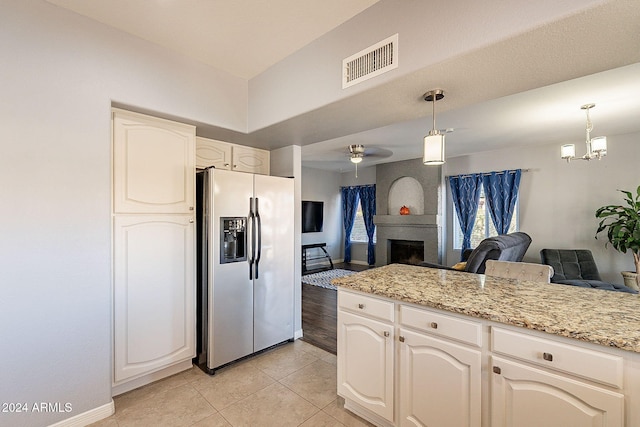 242 E Stonebridge Dr, Gilbert, AZ 85234 - kitchen featuring stainless steel refrigerator with ice dispenser, open floor plan, light tile patterned floors, decorative light fixtures, and a ceiling fan