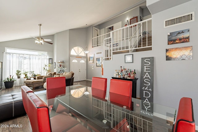 dining space featuring hardwood / wood-style floors, ceiling fan, and lofted ceiling