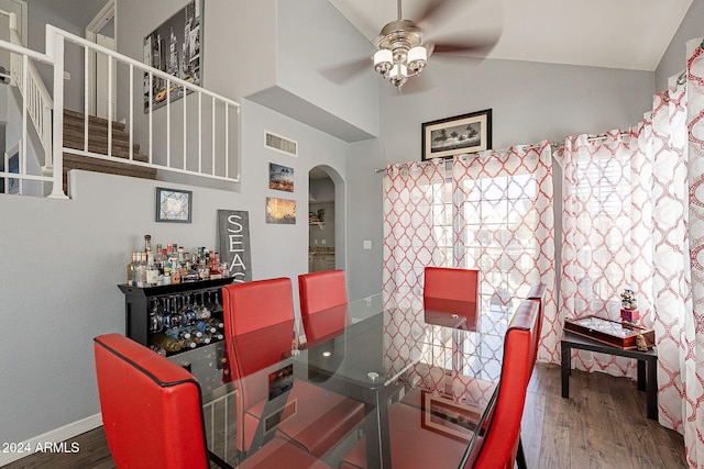 242 E Stonebridge Dr, Gilbert, AZ 85234 - dining area featuring ceiling fan, arched walkways, wood finished floors, high vaulted ceiling, and stairway