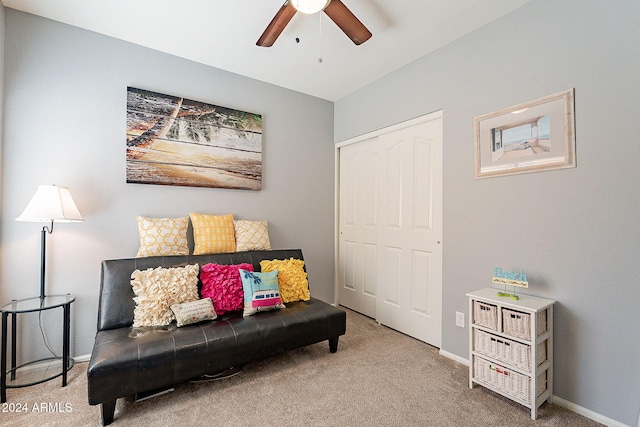 sitting room featuring carpet and ceiling fan