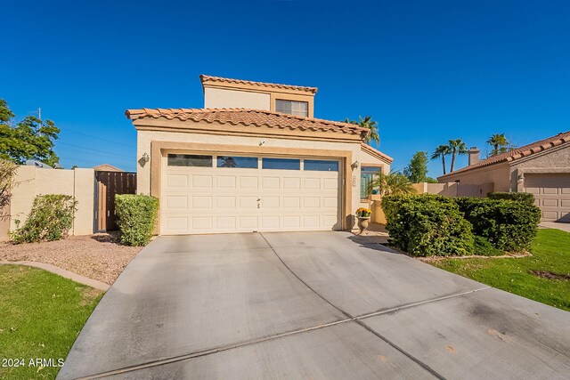 242 E Stonebridge Dr, Gilbert, AZ 85234 - mediterranean / spanish home featuring stucco siding, driveway, a tile roof, and an attached garage