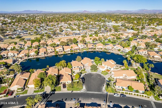 birds eye view of property with a water and mountain view